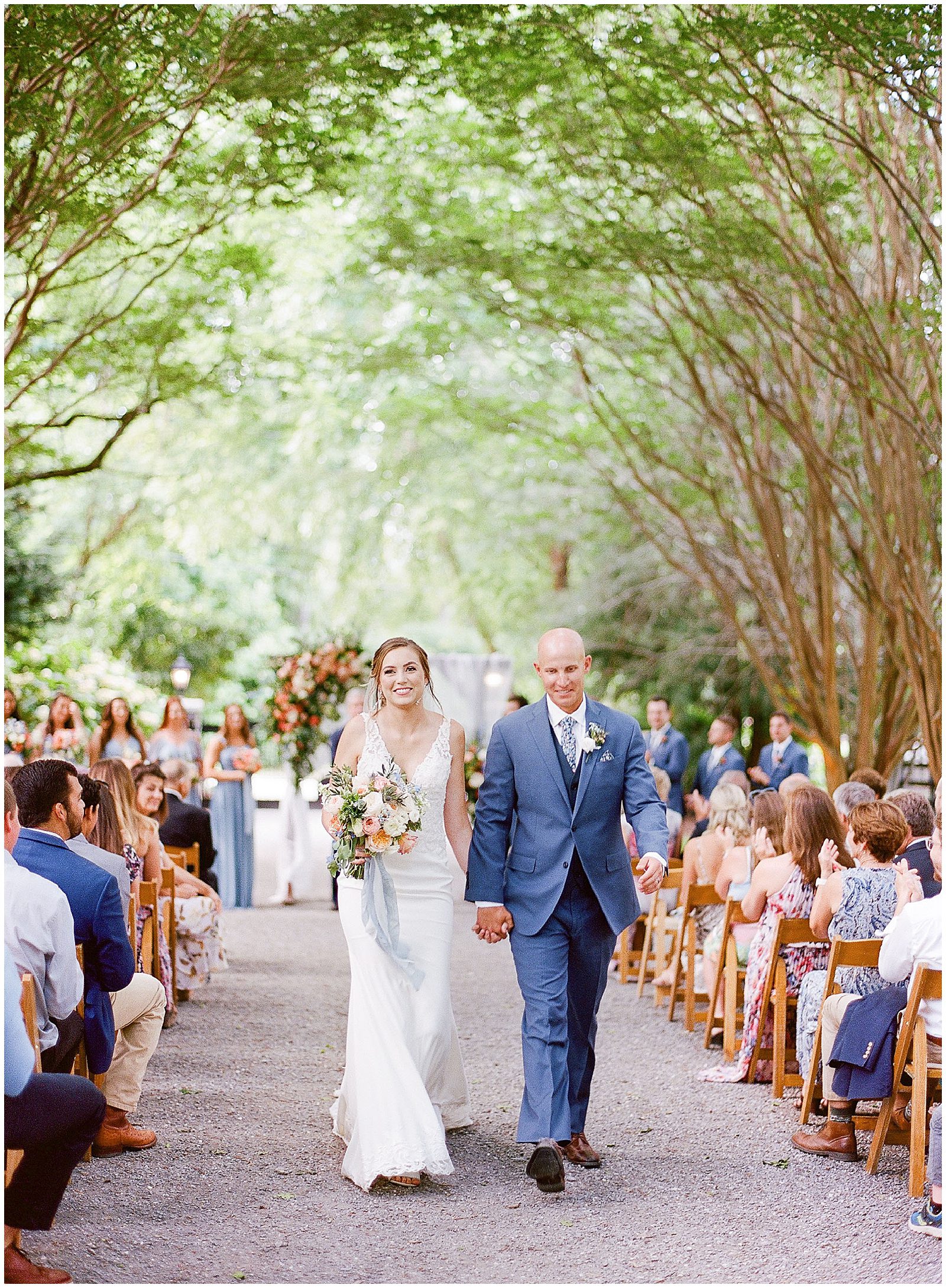 Bride and Groom Exiting Ceremony Under Trees Photo