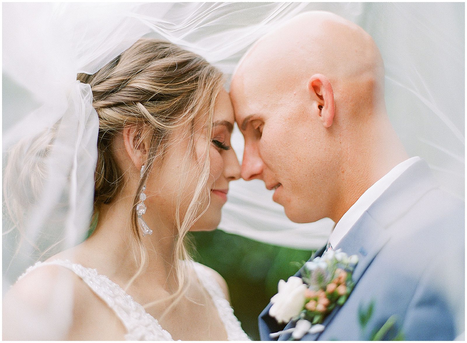 Couple Nose to Nose Under Brides Veil Photo
