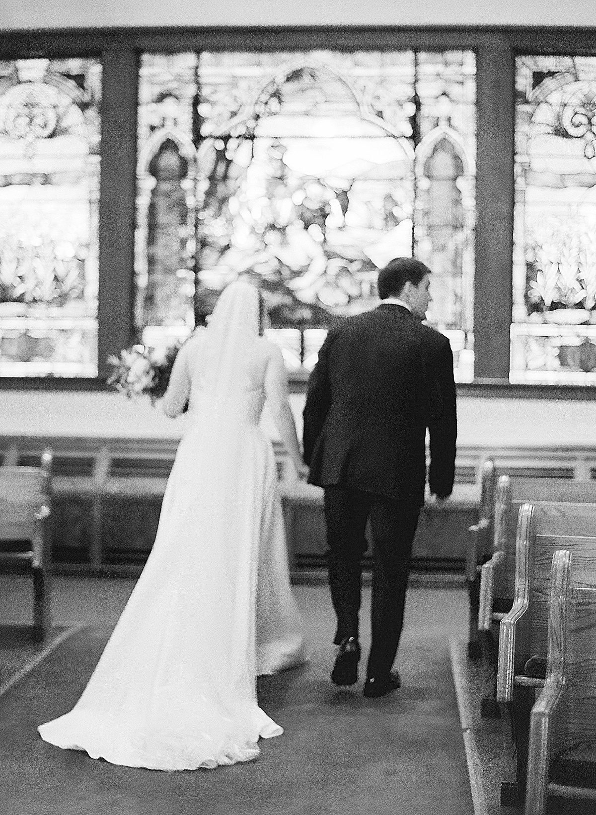 Black and White of Couple Walking Down Aisle at Methodist Church in Asheville Photo
