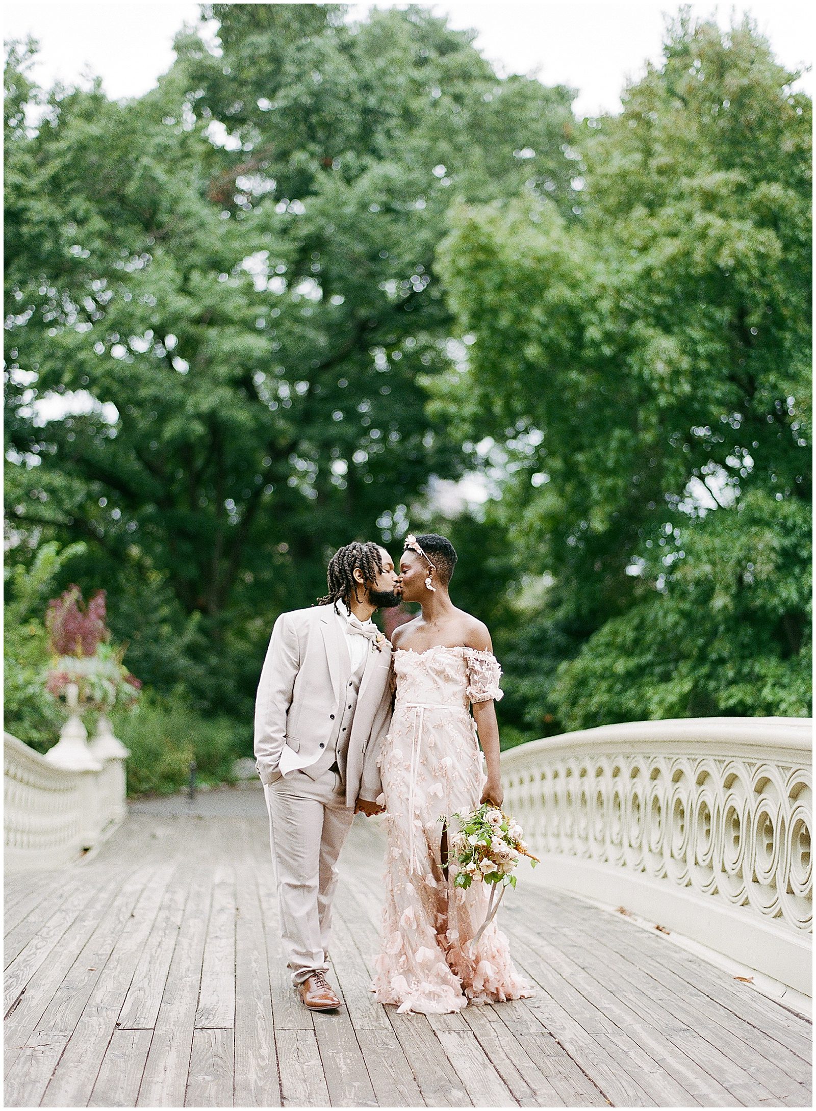 Central Park Wedding Bride and Groom Kissing on Bow Bridge Photo