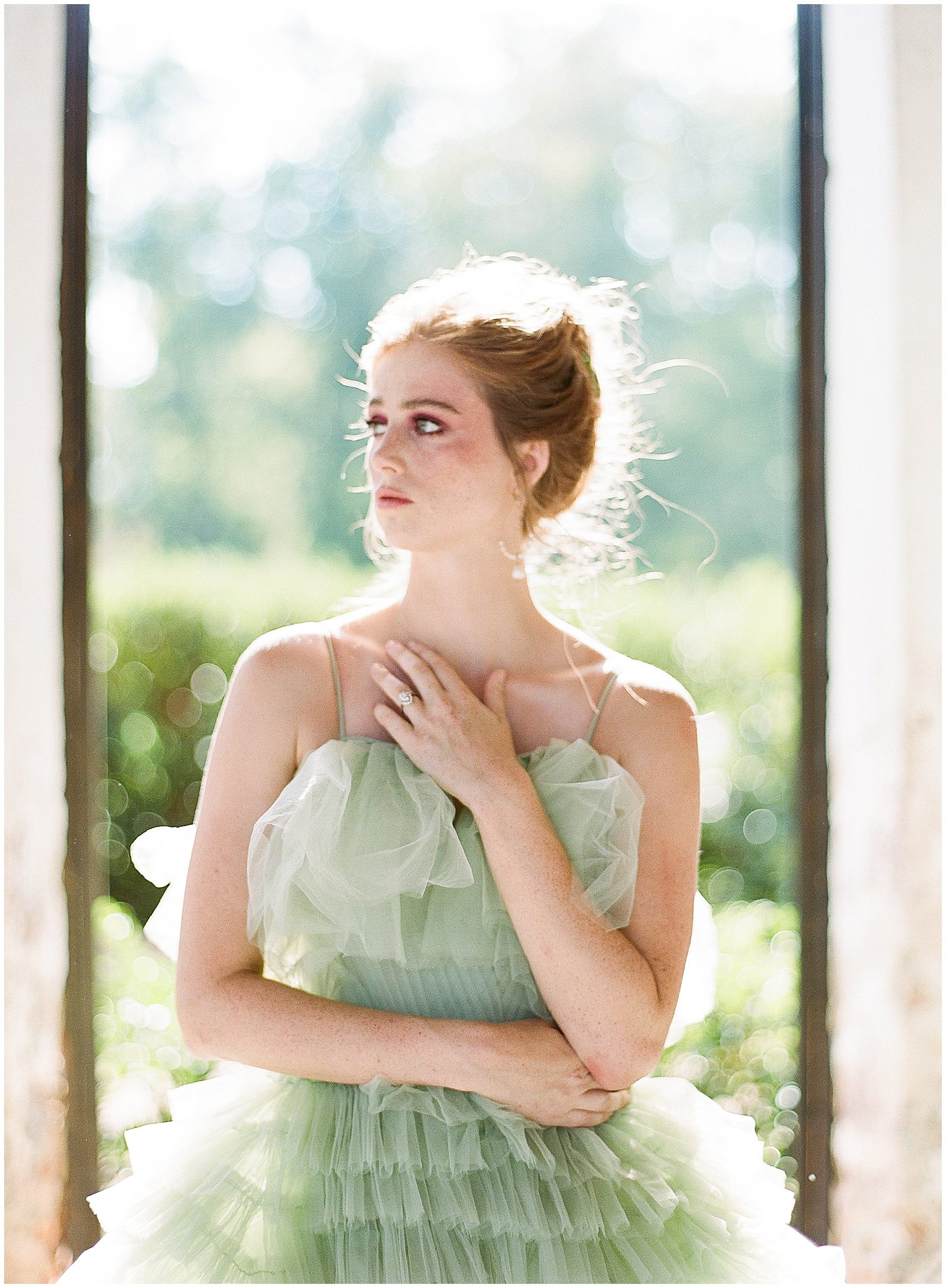 Bride in Green Wedding Dress Looking off with hand on Chest Photo