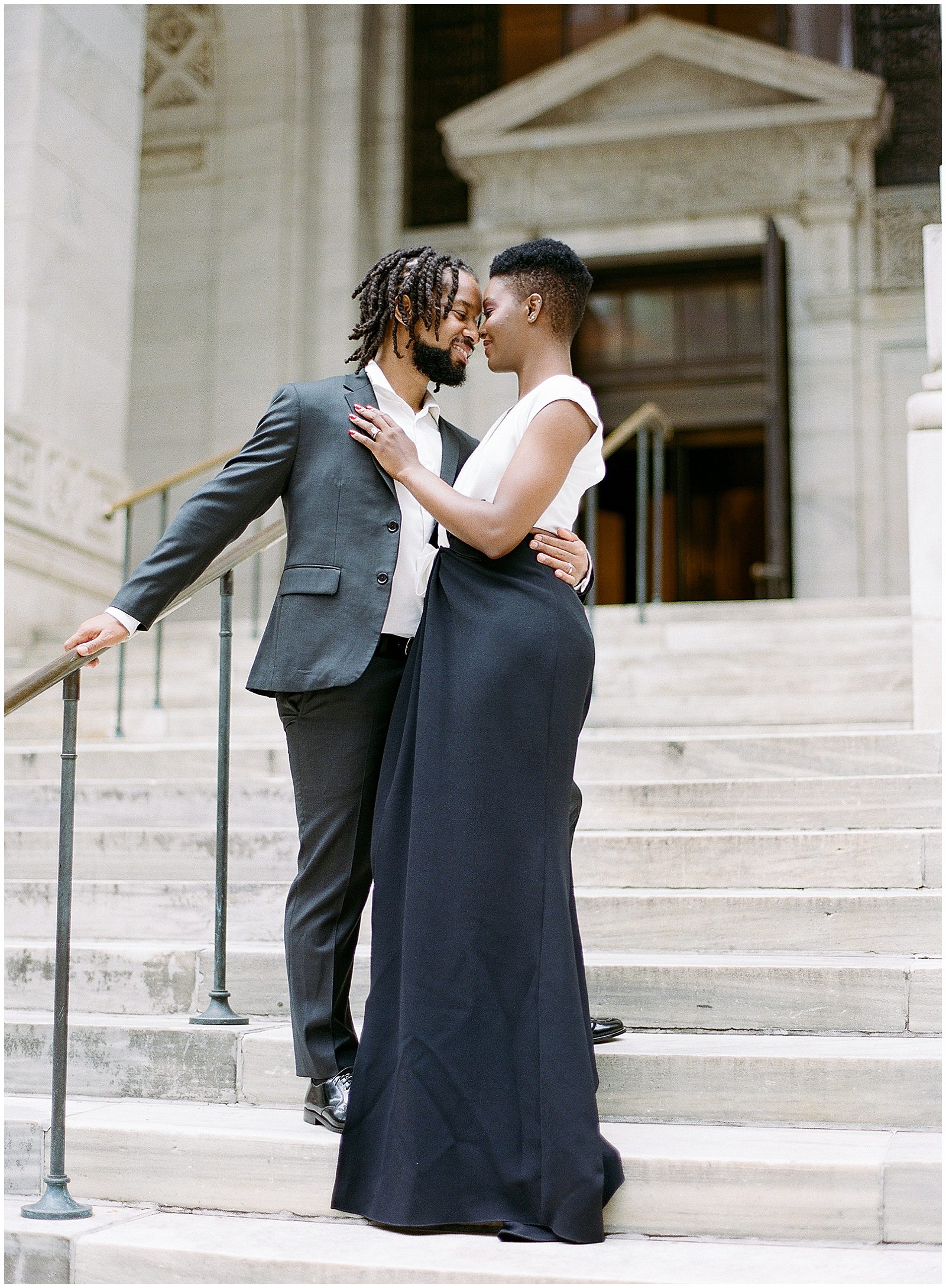 New York City Engagement Photos Couple Nose to Nose on Stairs at Library Photo