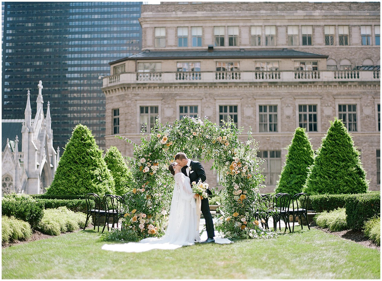 Bride and Groom Kissing at Flower Arch at New York City Wedding Venue 620 Loft and Garden Photo