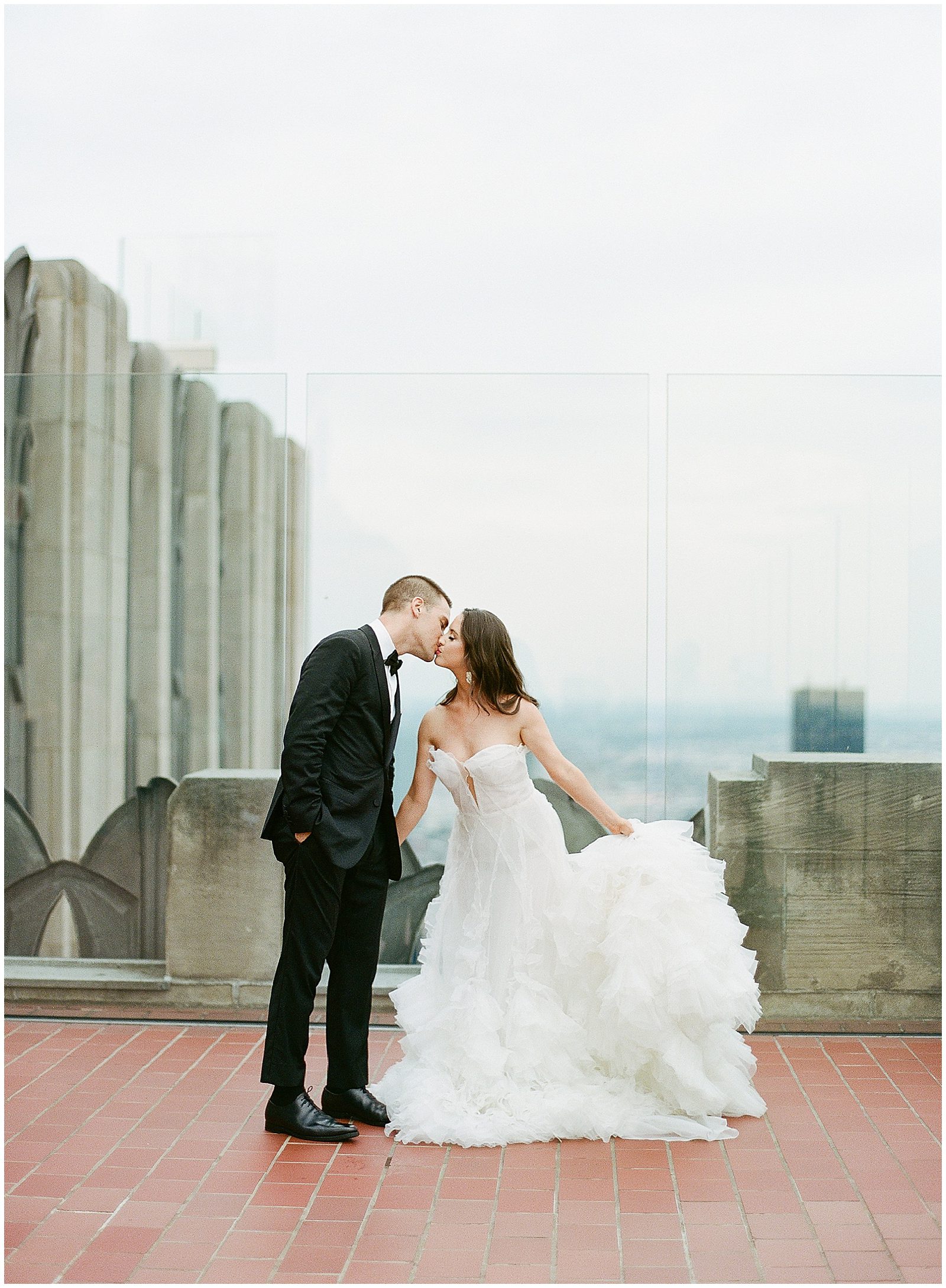 Bride and Groom Kissing at Top Of The Rock in New York City Photo