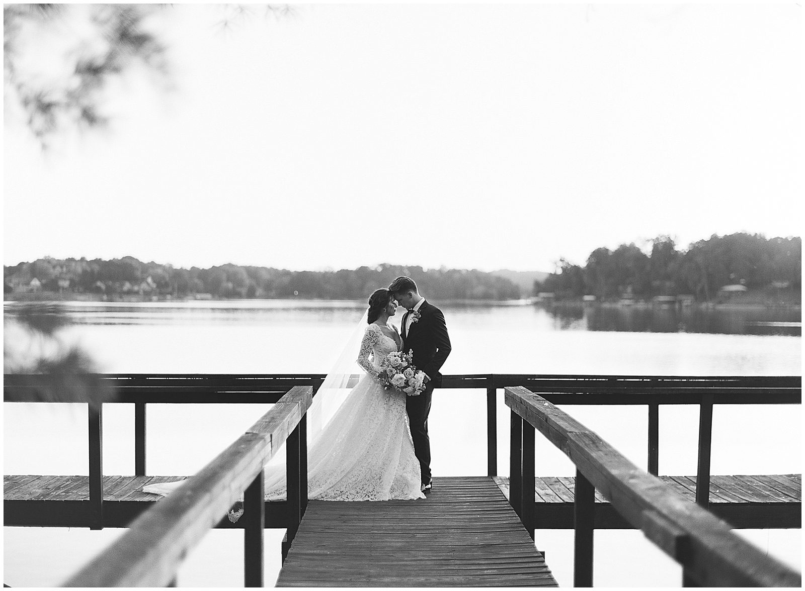 Black and White of Bride and Groom on Dock Photo