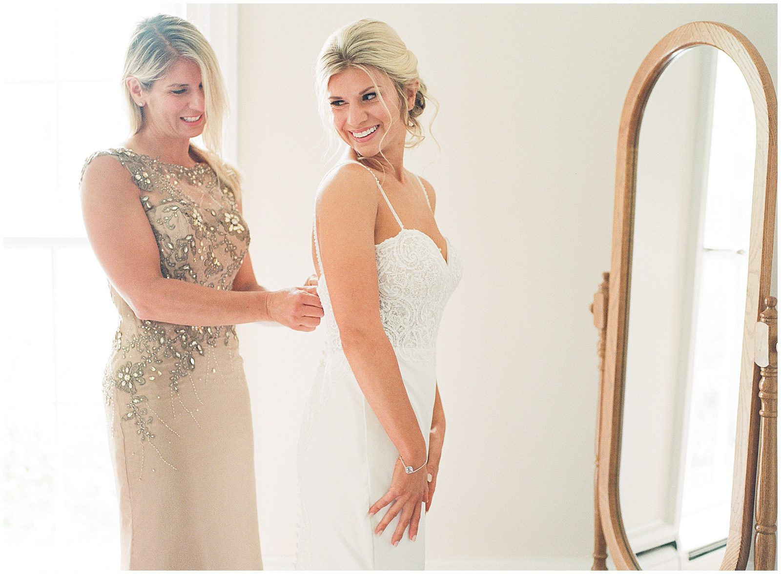 Bride Getting Dressed with Her Mom Photo