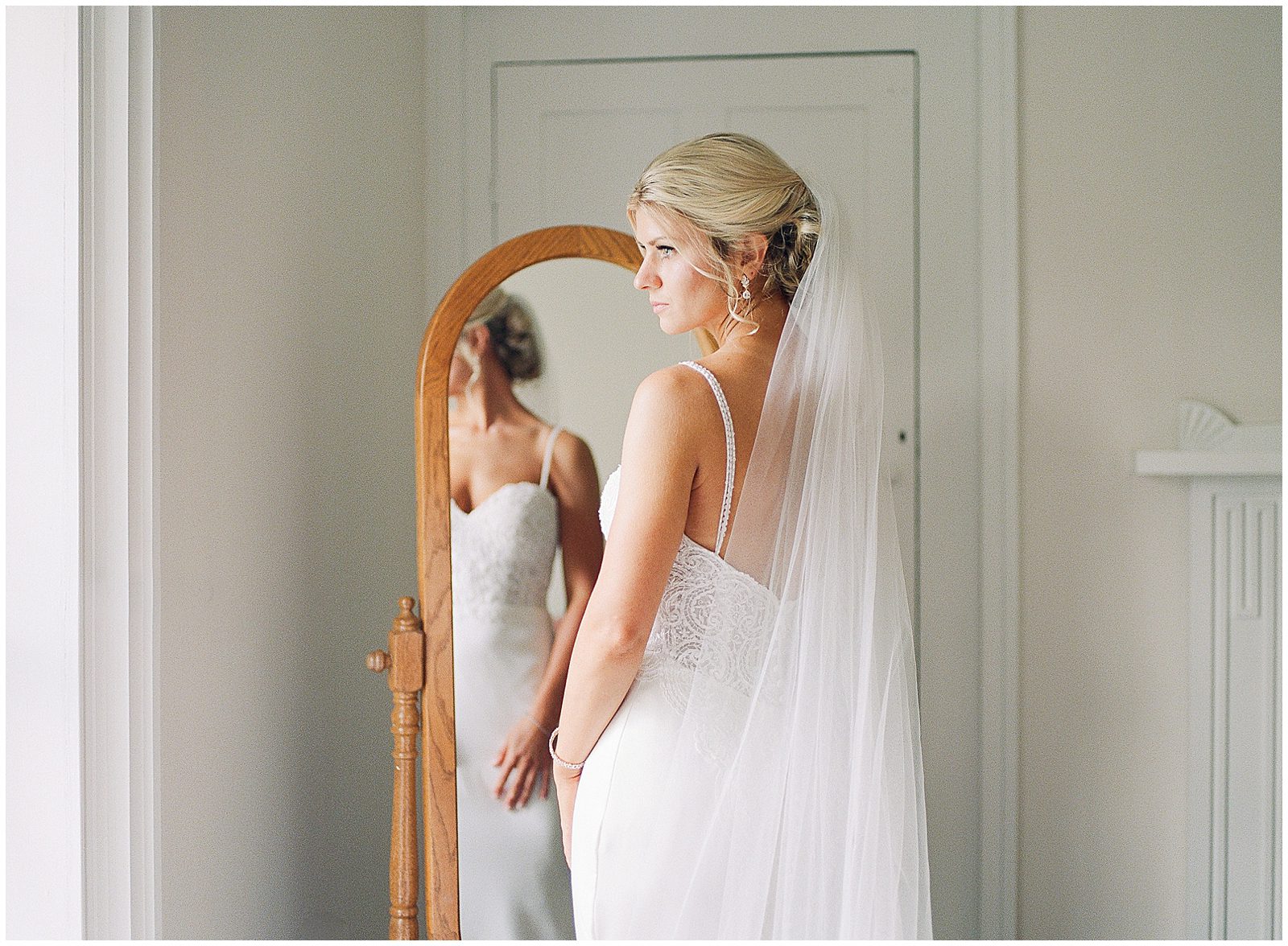 Bride Looking Out the Window While Getting Ready Photo