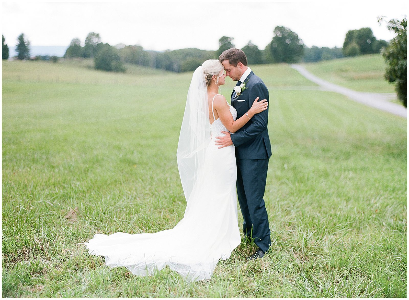 Bride and Groom Nose to Nose in Field Photo