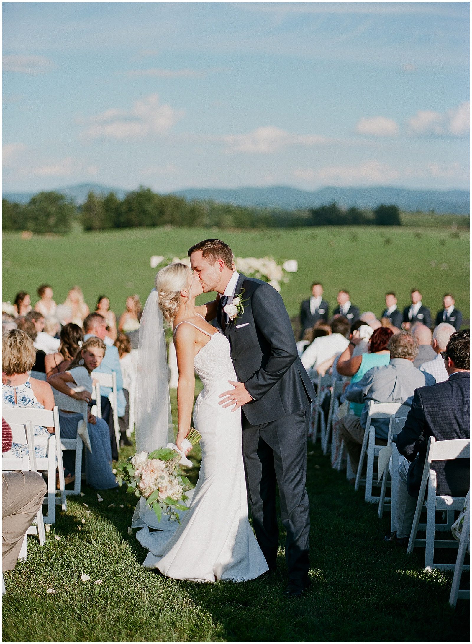 Bride and Groom Kissing in Aisle Photo