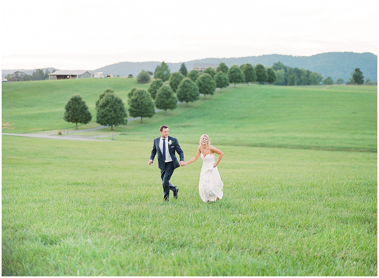 Bride and Groom Running in Field Photo