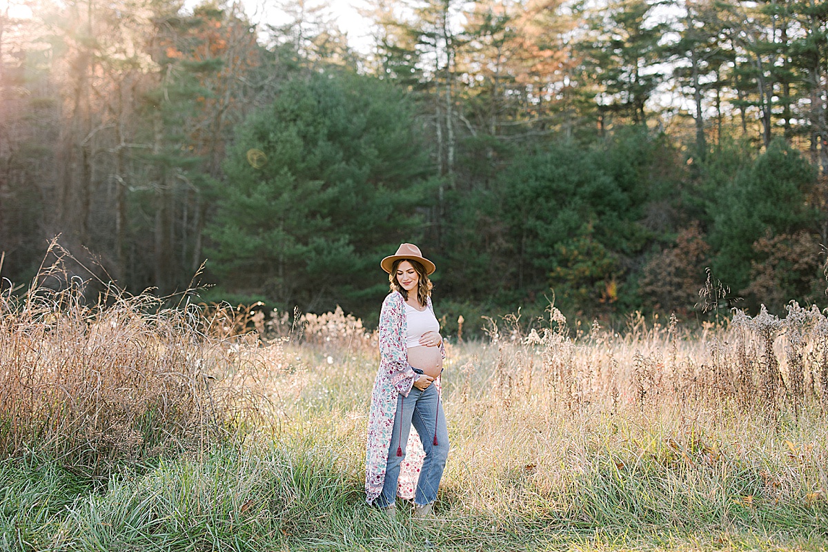 Asheville Maternity Session Mom in Field Holding Belly Photo