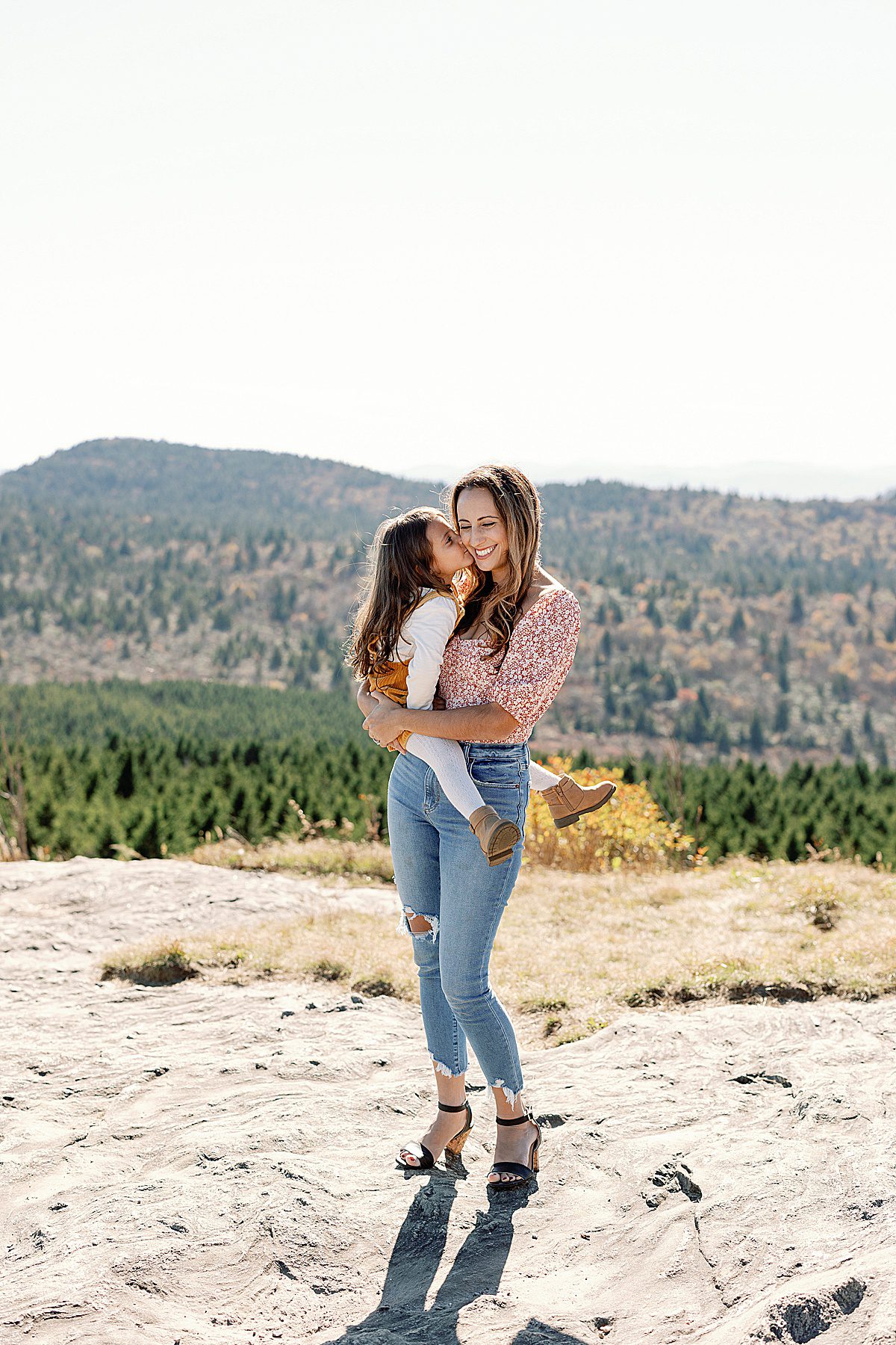 Mother Daughter Kissing in Mountains Photo