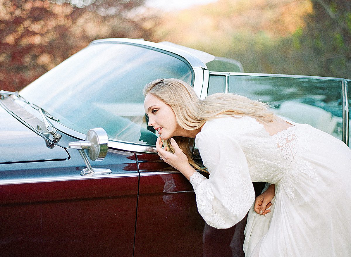 Bride Fixing Makeup in Car Review Mirror Photo