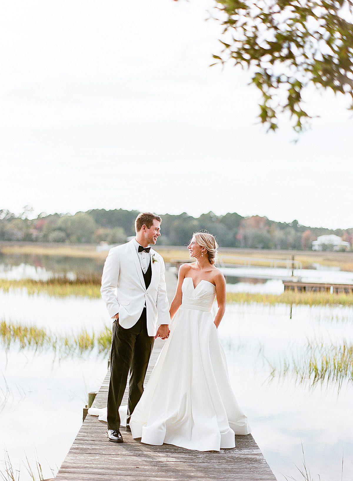 Wedding Venue In Charleston Bride and Groom On Dock Smiling at Each Other Photo