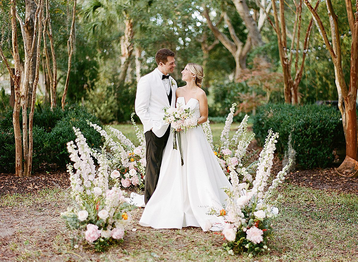 Bride and Groom Surrounded by Flowers Photo