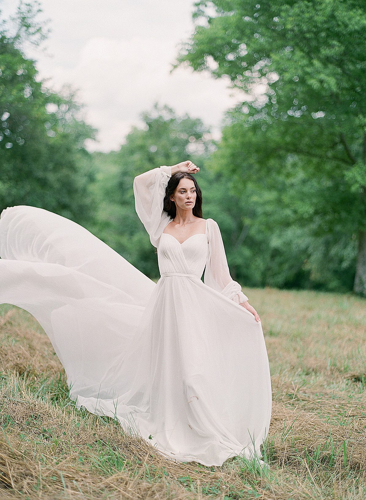 Bride Walking Through Field in Alon Livne White Gown Photo