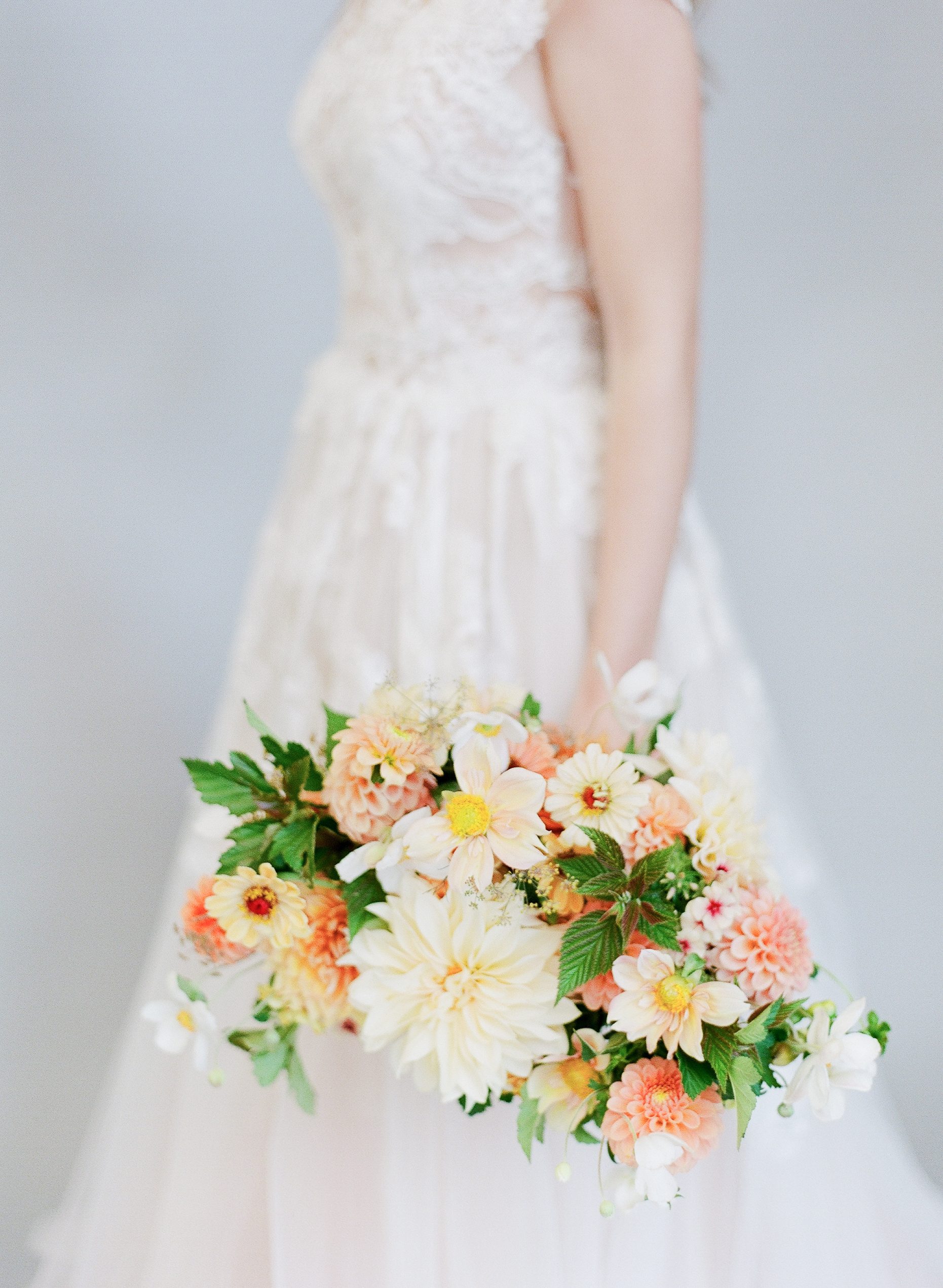 Bridal Bouquet Inspiration bride holding orange and white bouquet