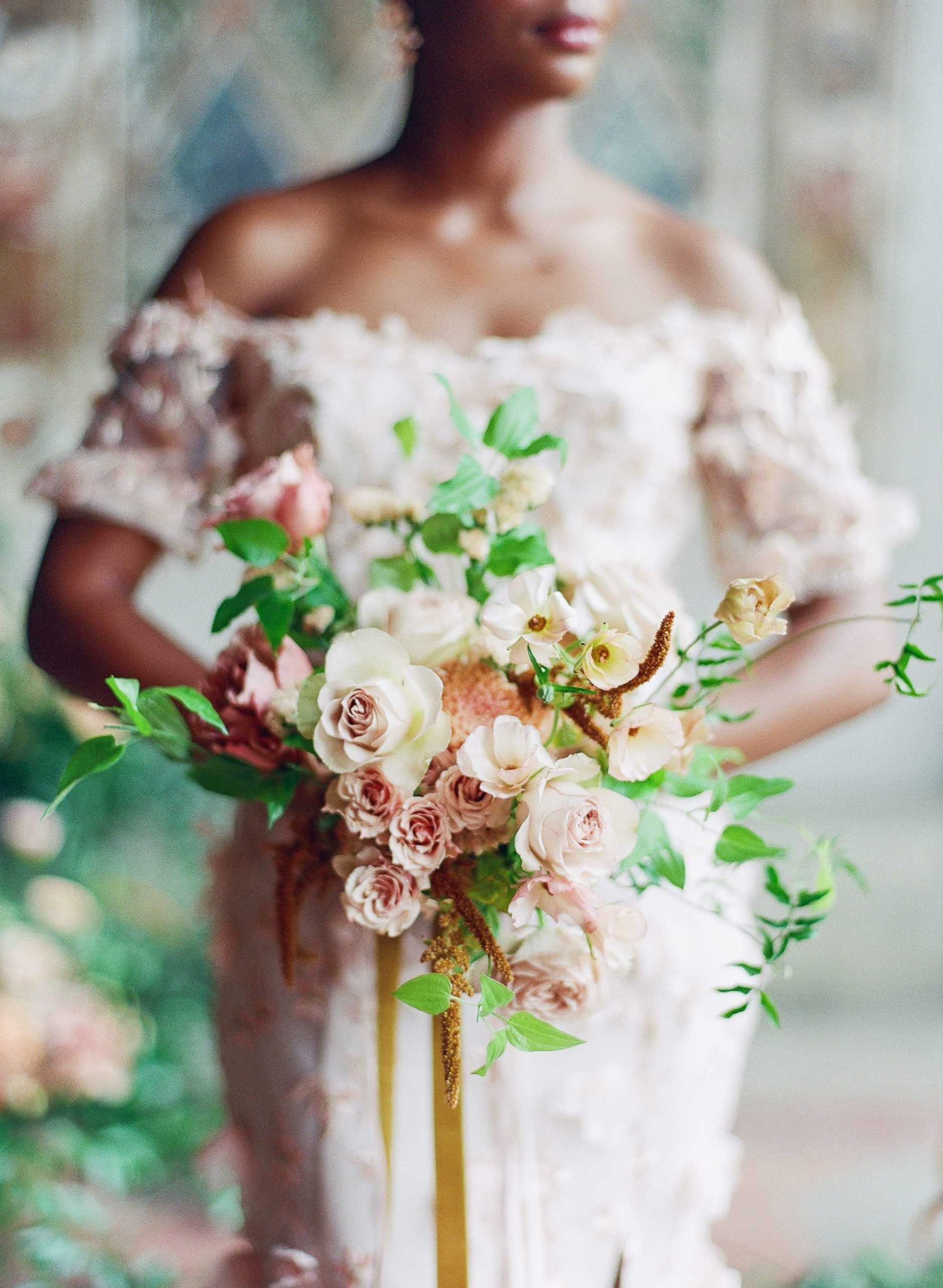 Bride holding pink and white bridal bouquet photo