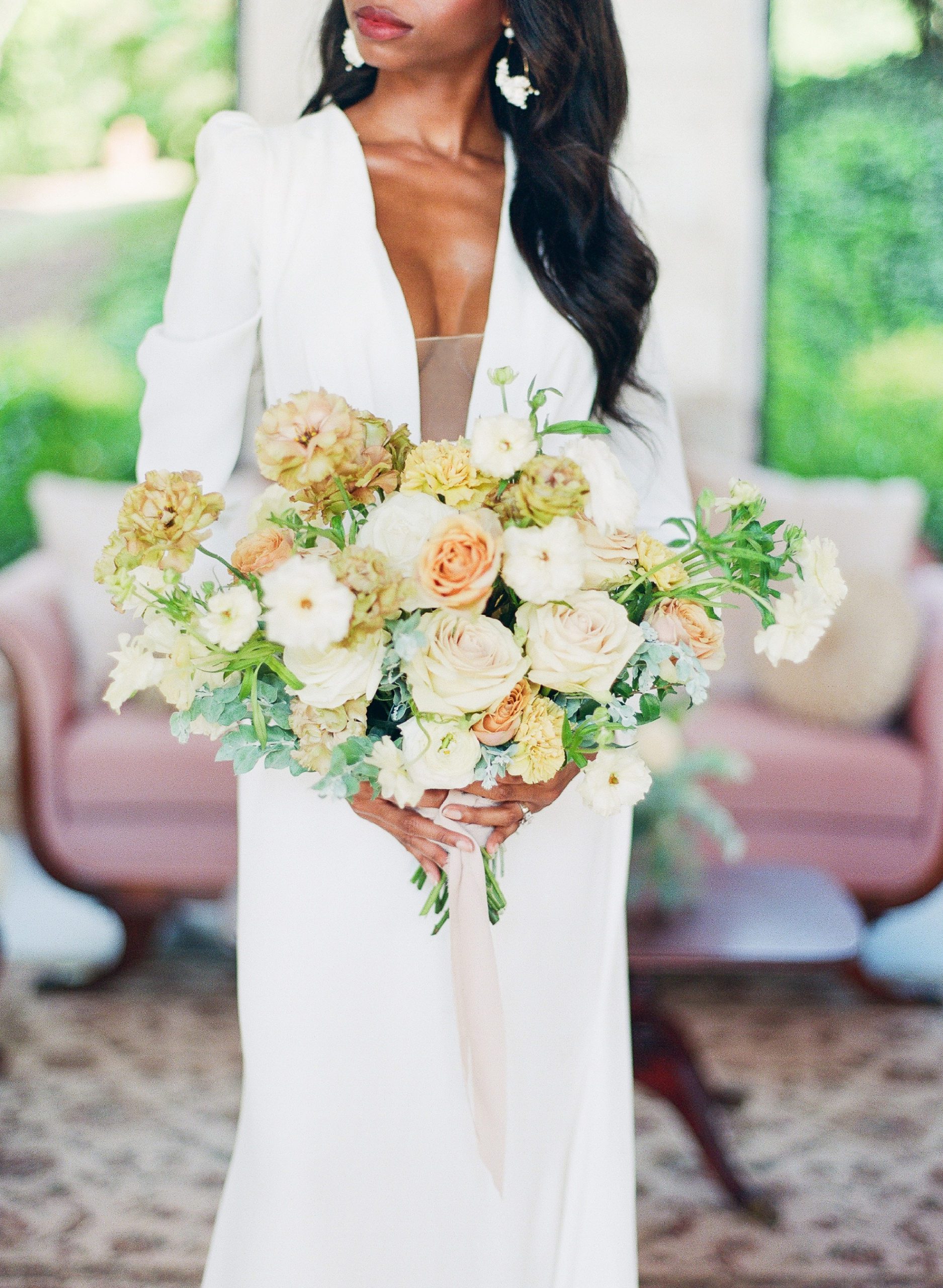 Bride Holding peach and white bridal bouquet photo
