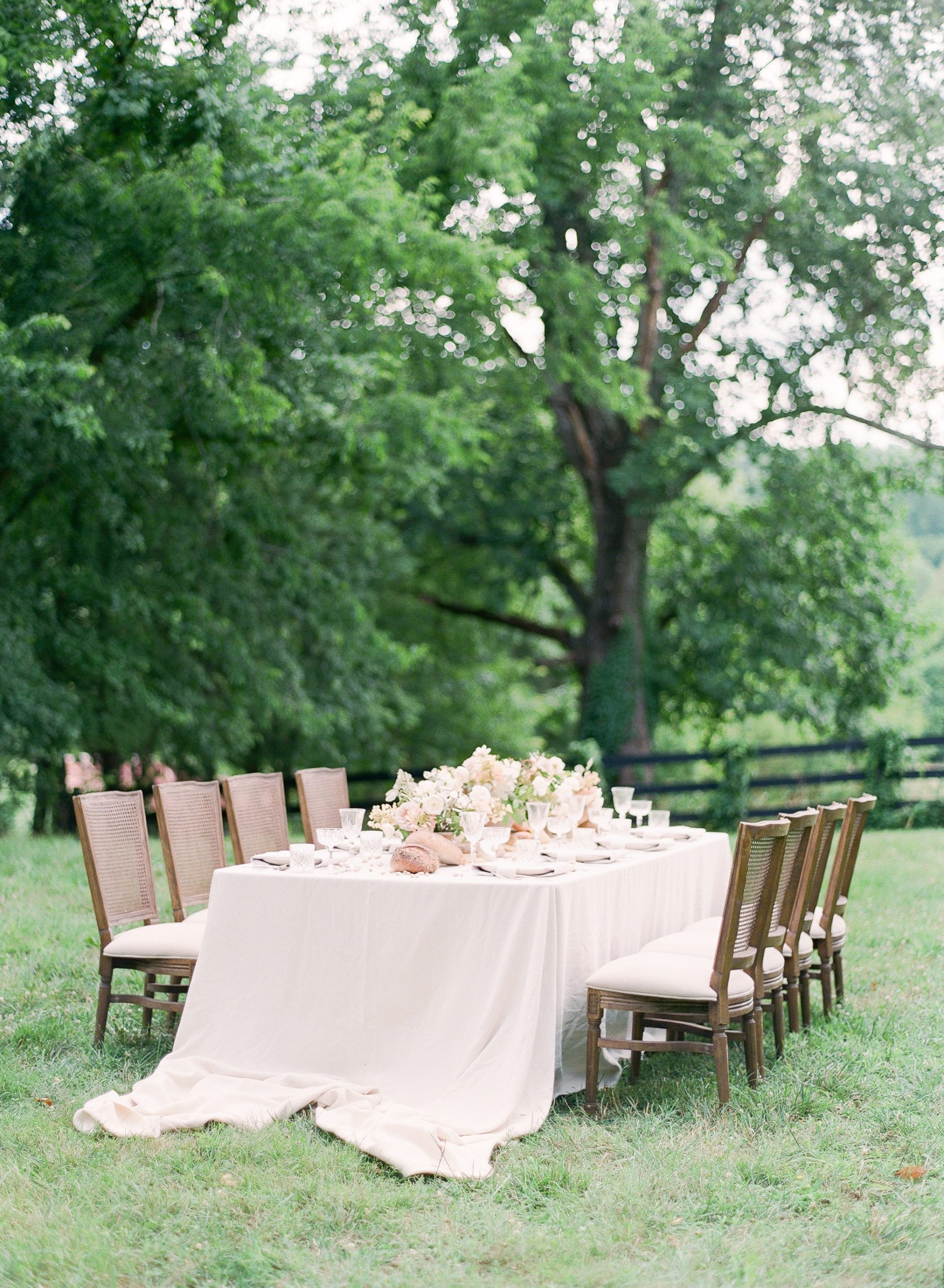 Wedding Reception Table with white linen and flowers photo