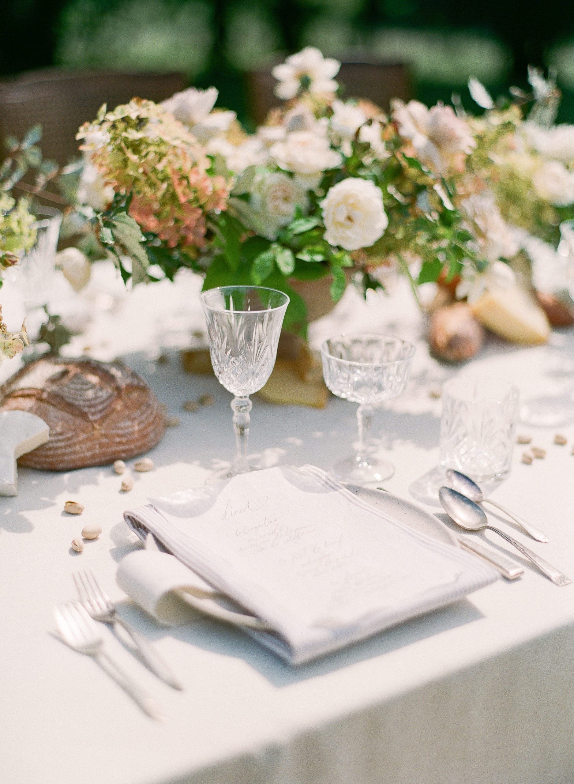 Wedding Reception Table Place setting with flower centerpieces and bread loafs photo