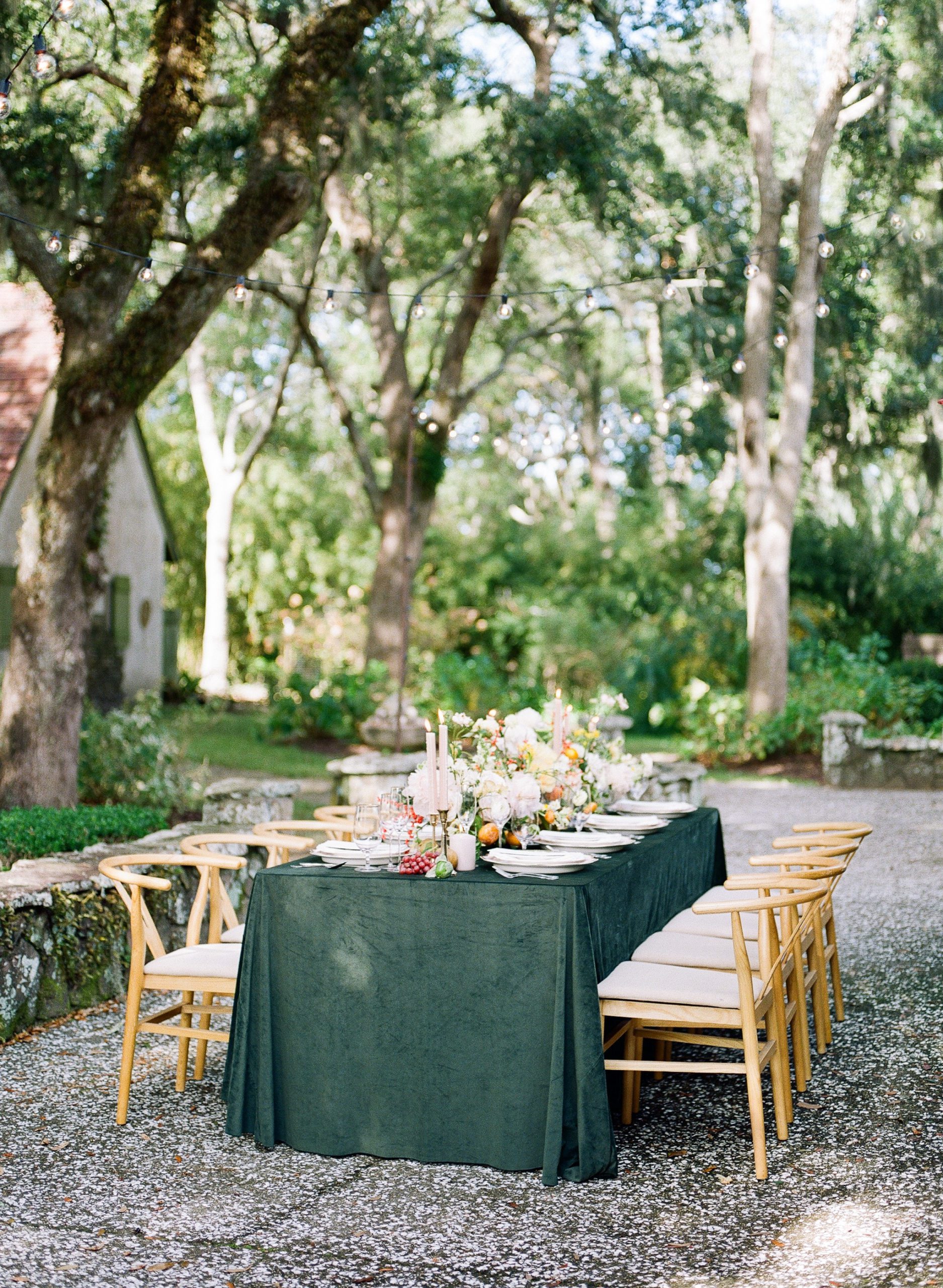Wedding Reception Table with Green Velvet Tablecloth and pink pillar candles photo