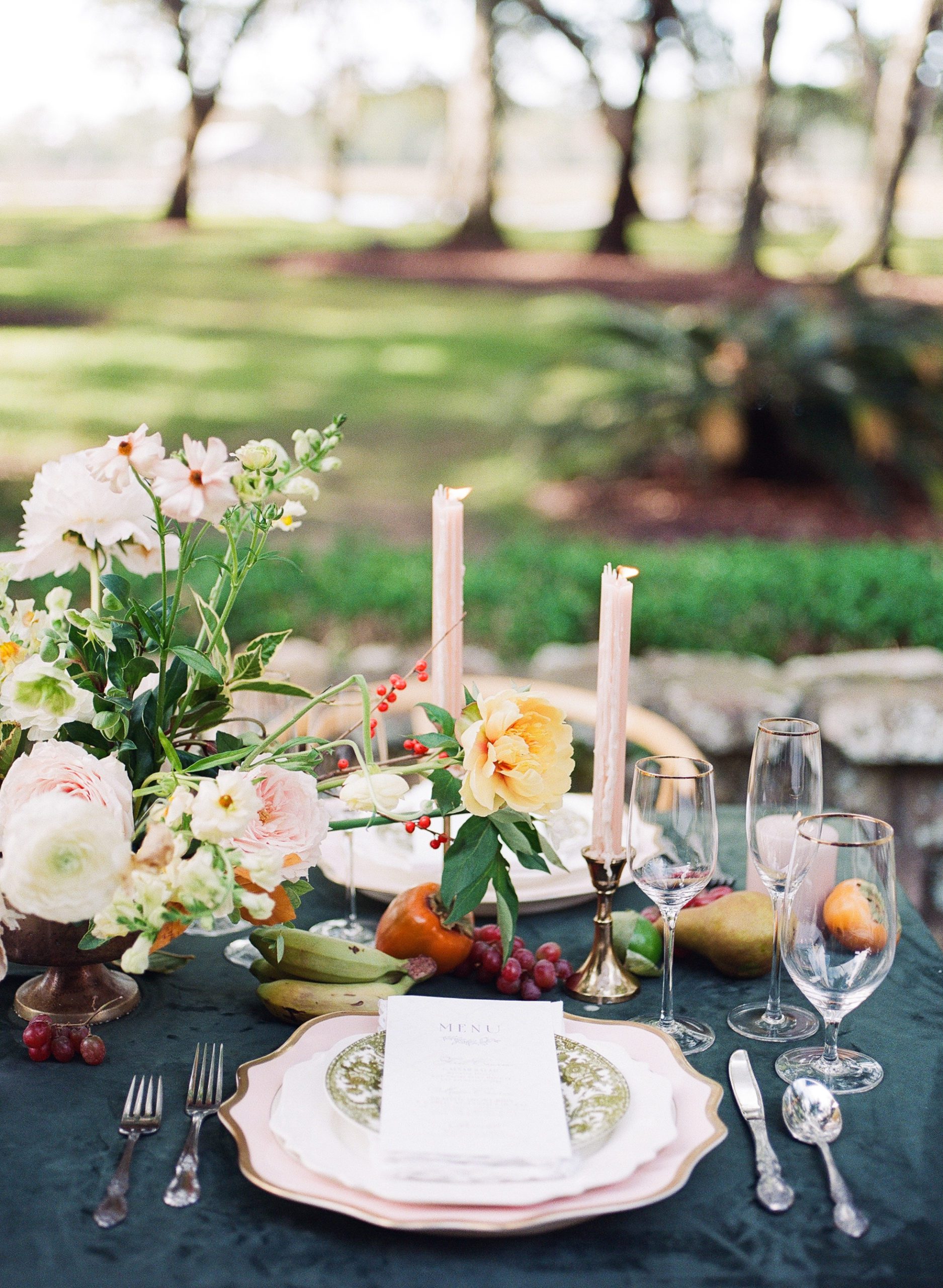Wedding Reception Table with Green Velvet Tablecloth and pillar candles photo