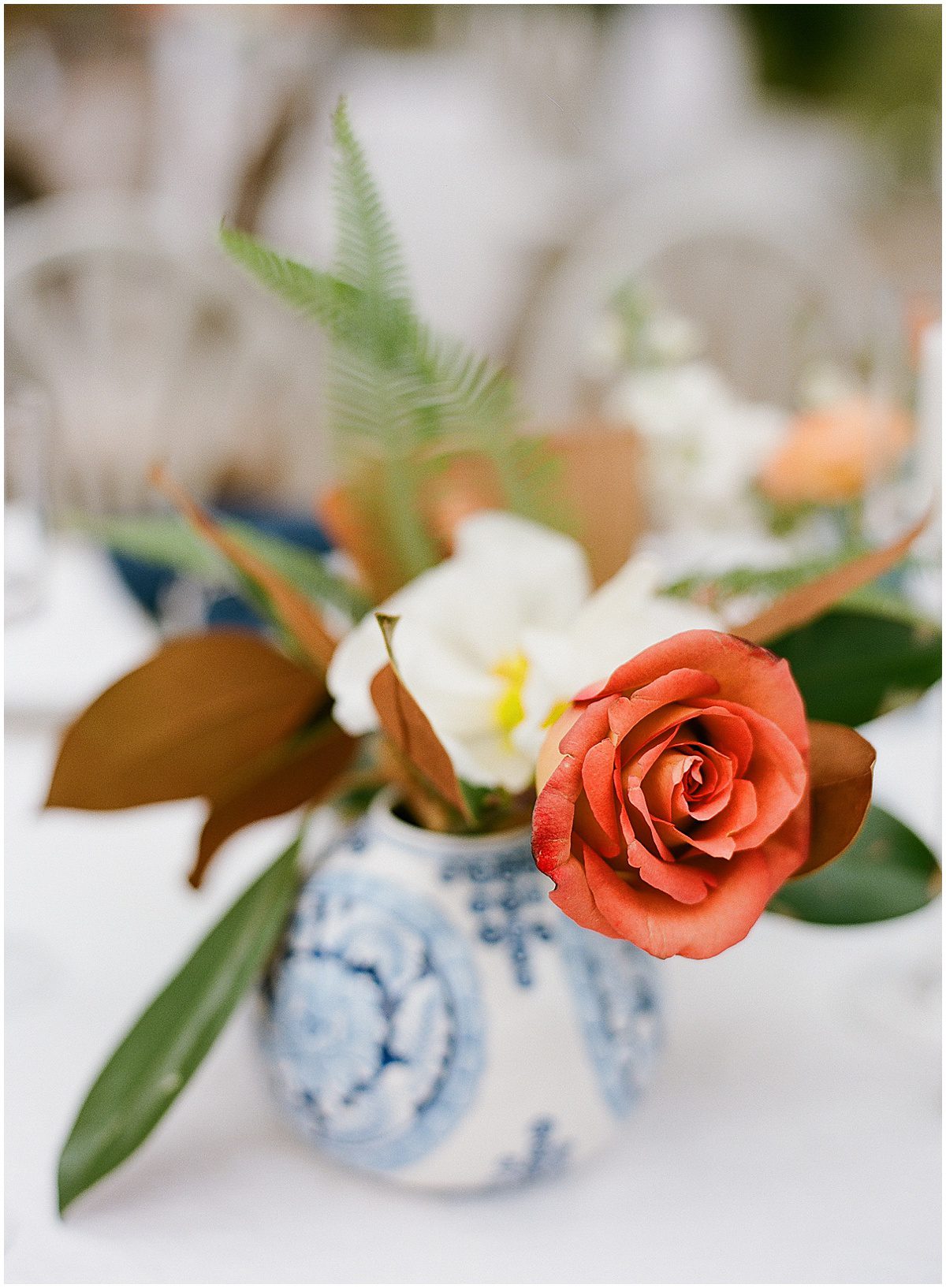 Blue and White Toile Vase with Orange Flowers Photo
