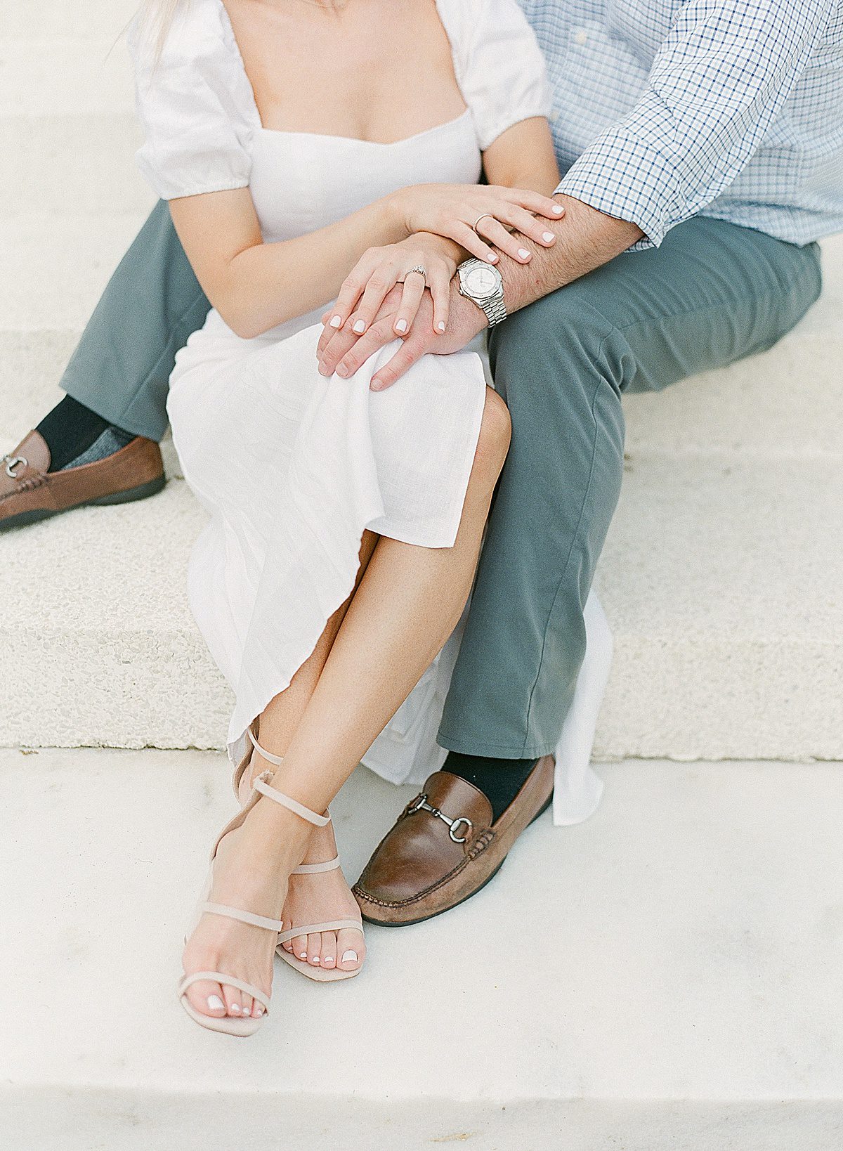 Couples Legs Crossed Holding Hands at The Ford Field & River Club Photo