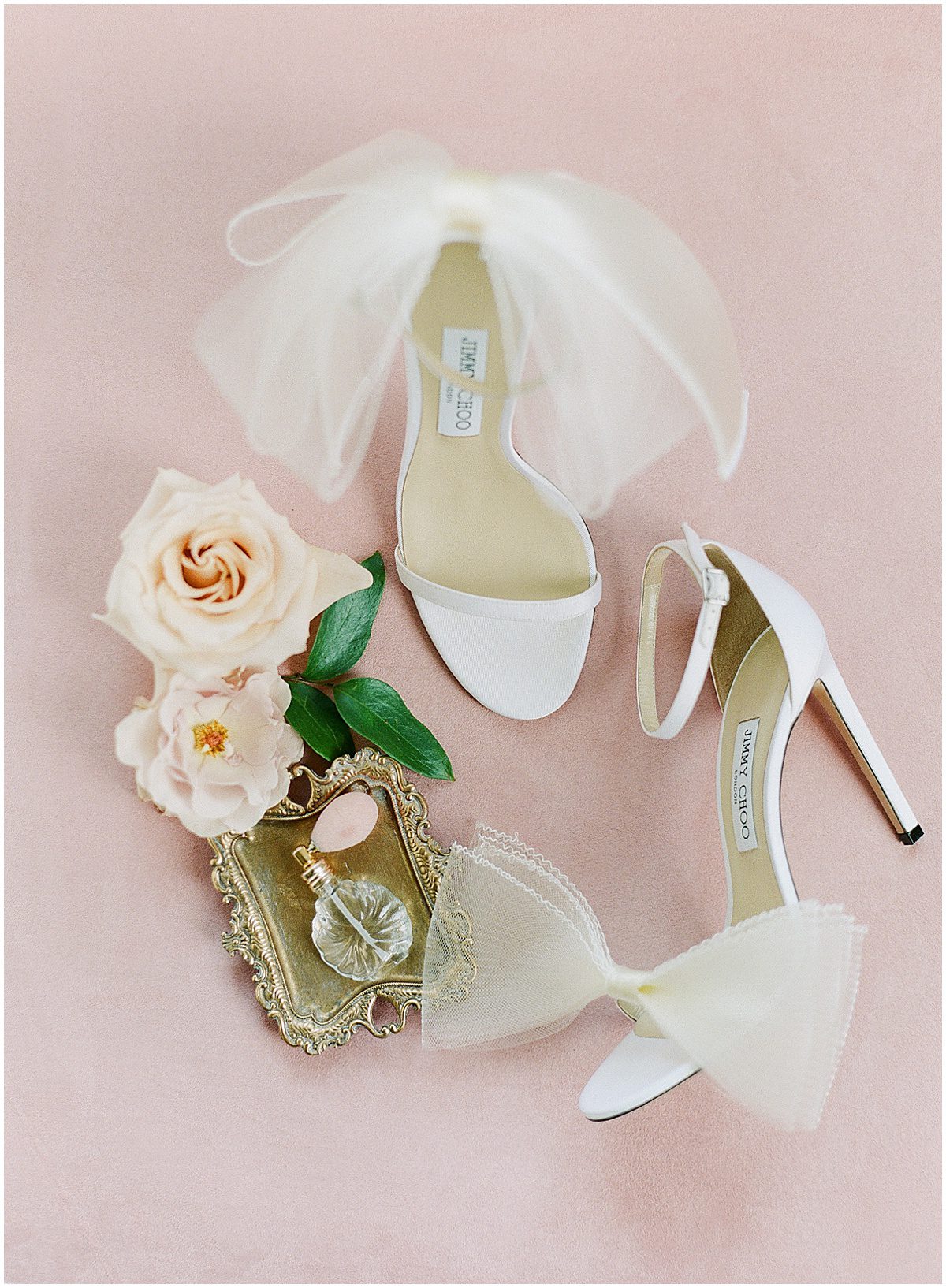 White Jimmy Choo Heels with a Bottle of Perfume and Flowers Photo