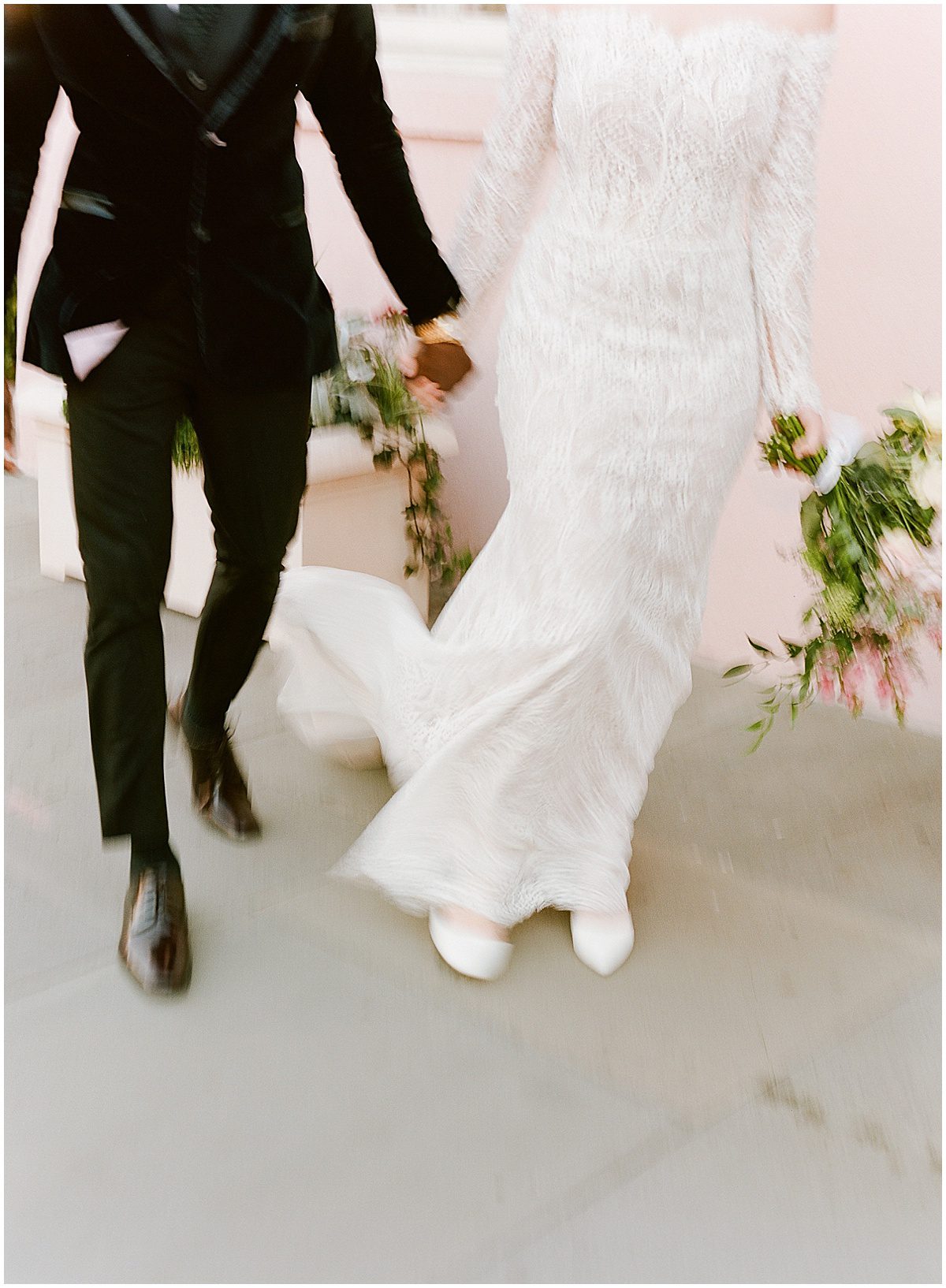 Bride and Groom Walking Holding Hands Blurry Photo