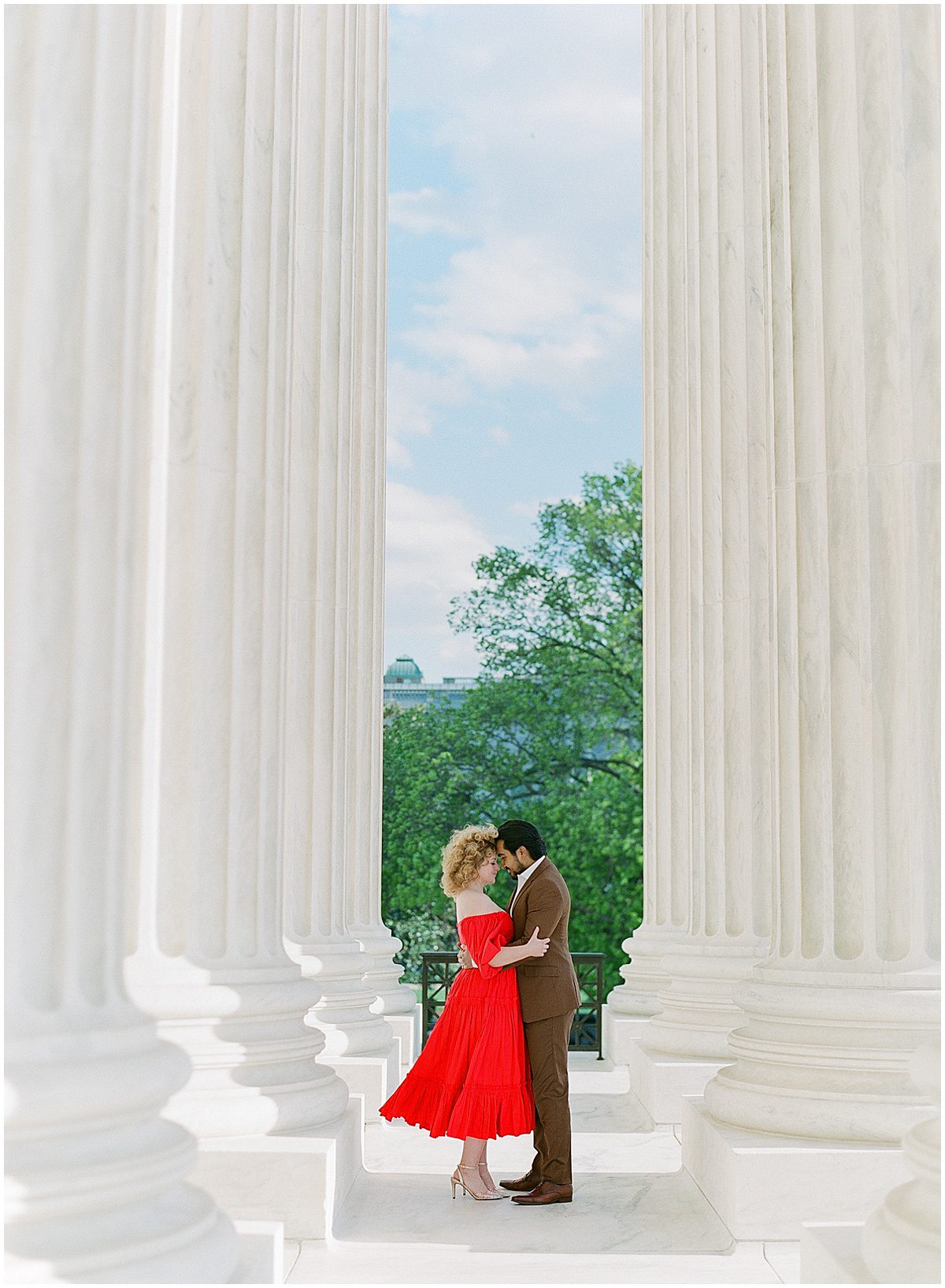 Lady in Red Dress Hugging Man During Capitol Hill Washington DC Engagement Session Photo