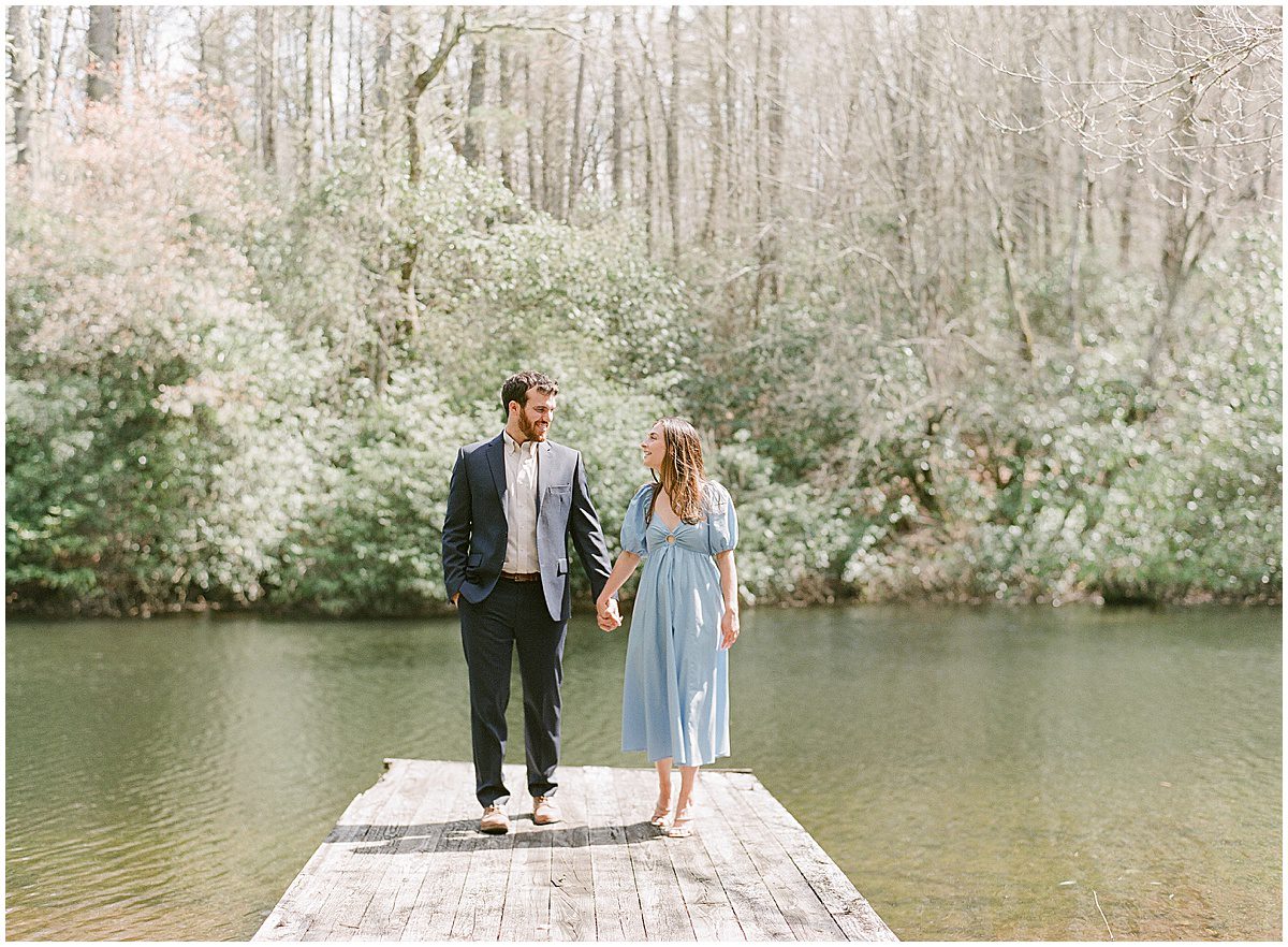 Couple on Dock Holding Hands In Cashiers NC Photo