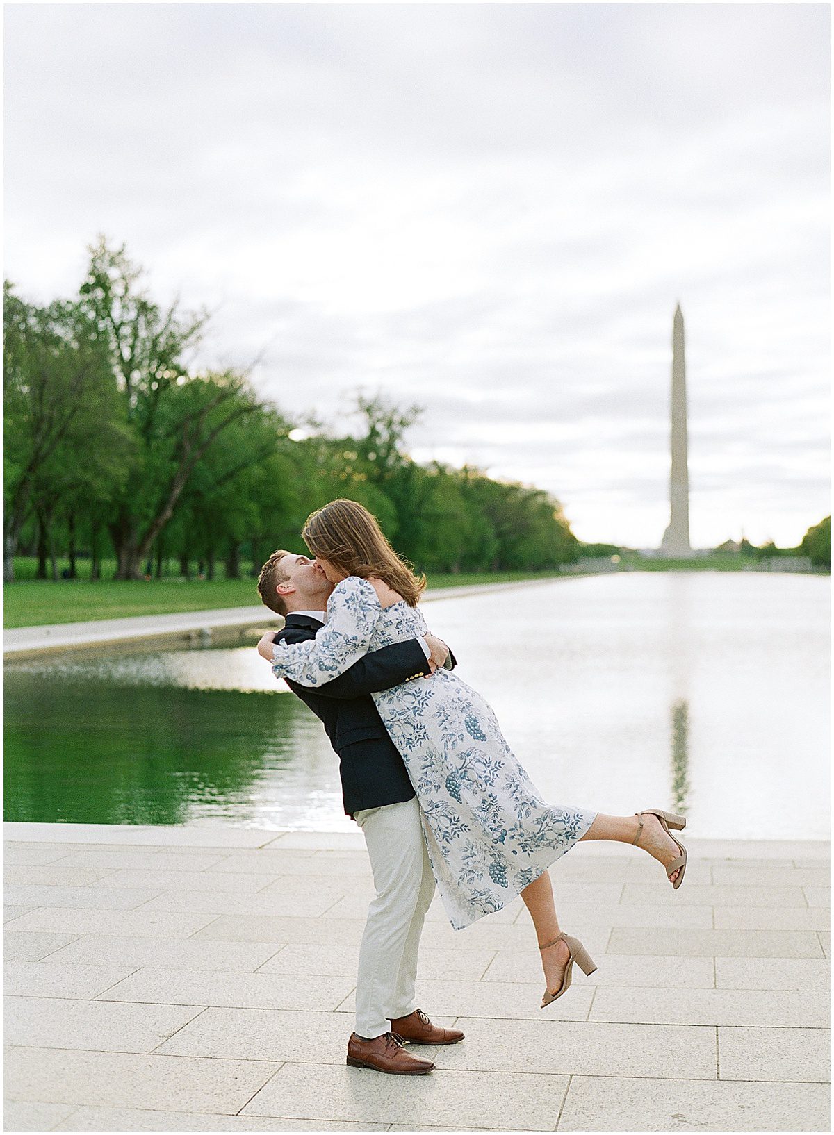 Couple Kissing With Washington Monument in the Background Photo