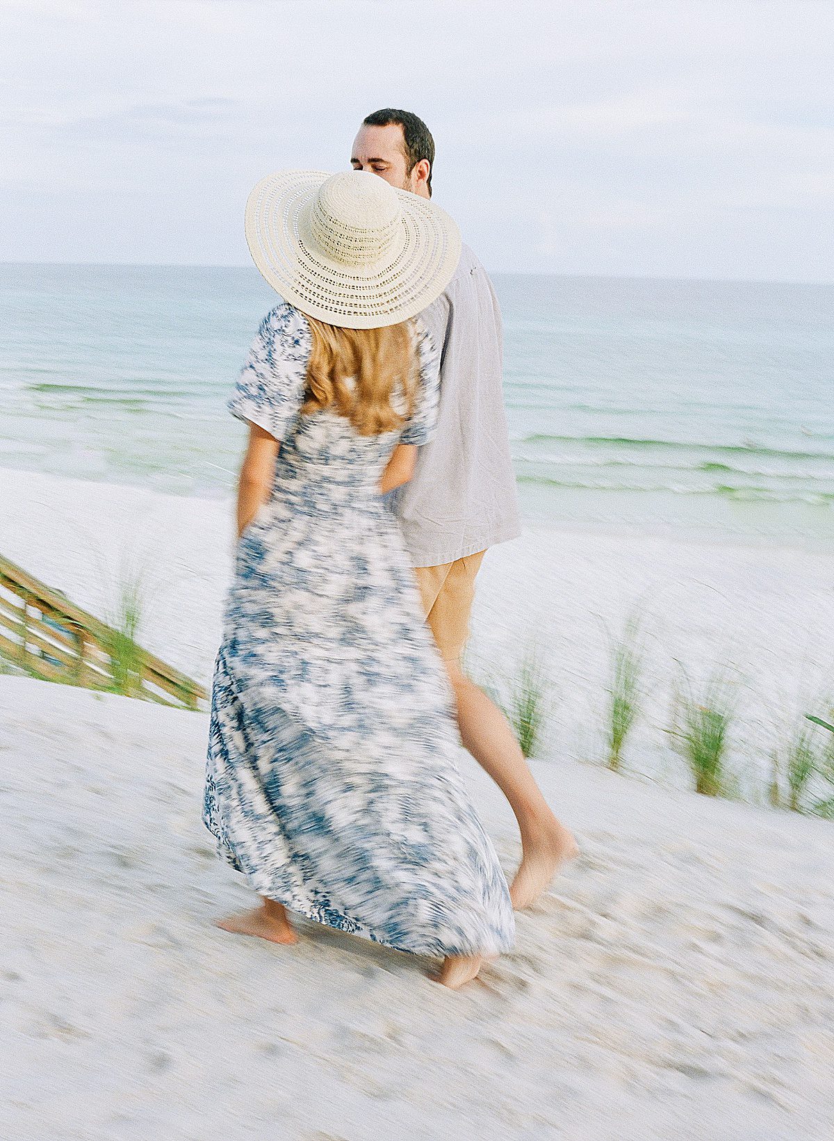 Motion Blur Photo Of Couple Walking in The Sand Photo