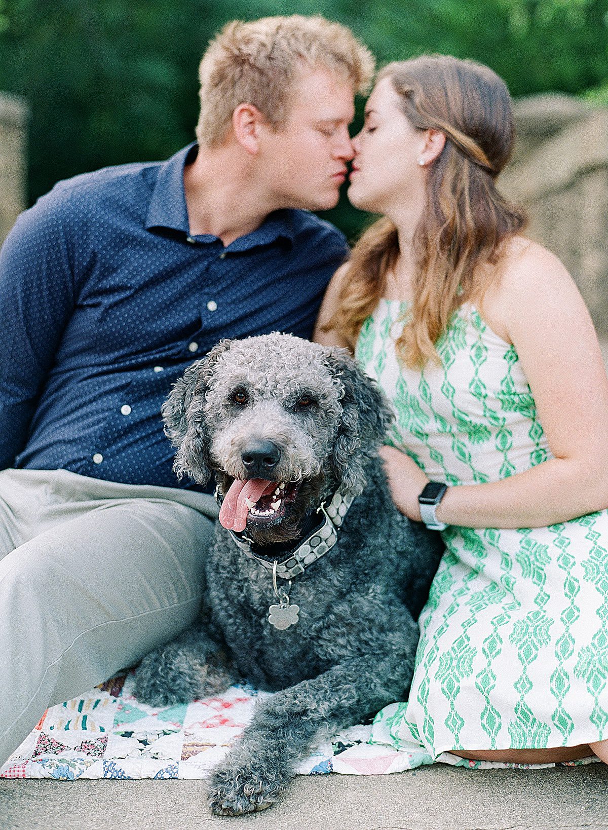 Bride and Groom Sitting on Blanket with Doodle Dog Photo