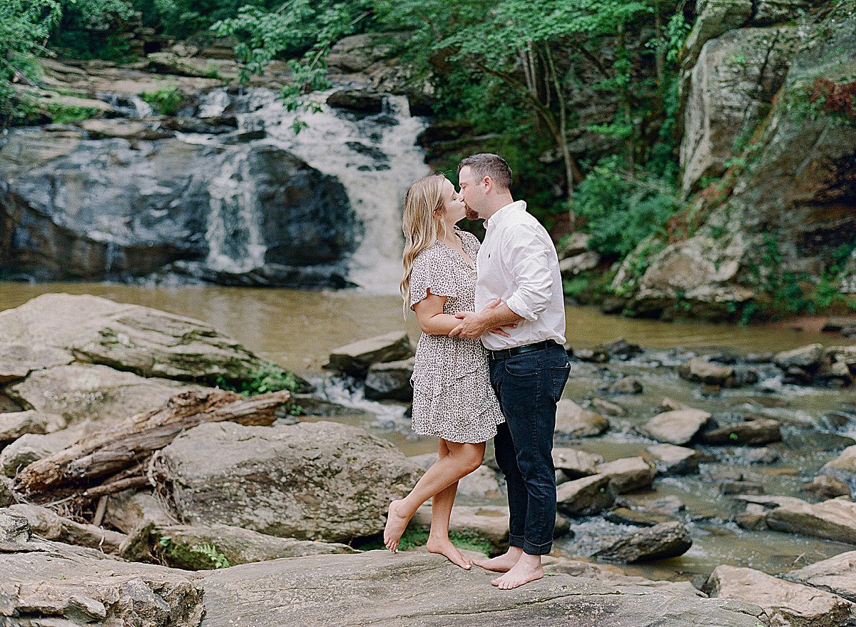 Couple Kissing in Front of waterfall Photo