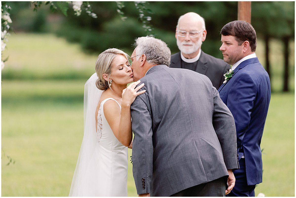 Dad Kissing Bride on The Cheek at The Alter Photo