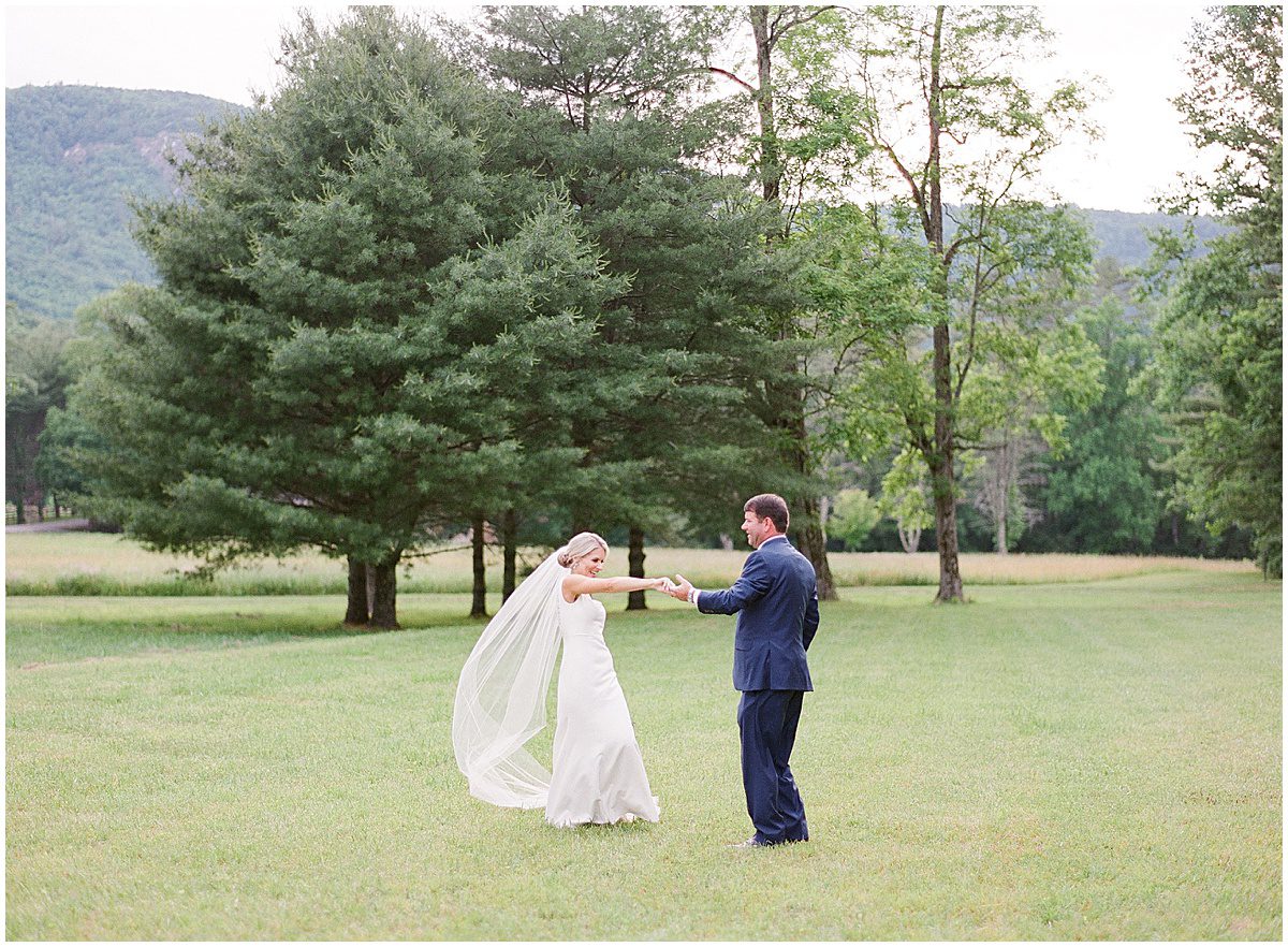 Bride and Groom Dancing in Field Photo