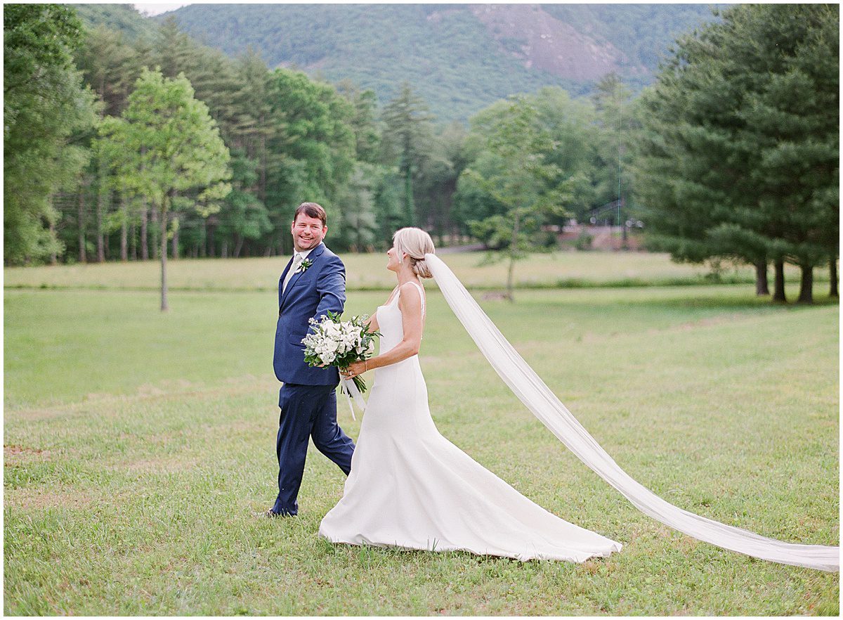 Highlands North Carolina Wedding Bride and Groom Holding Hands Walking in Field Photo