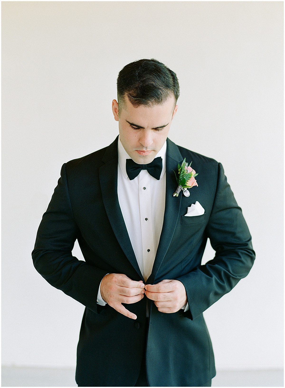 Groom Buttoning Coat at The Ridge Asheville Photo