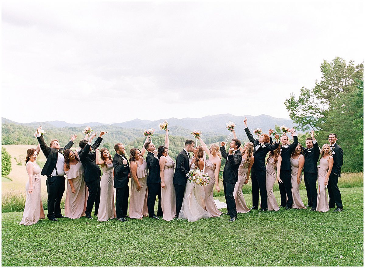 Bride and Groom with Wedding Party Cheering Photo