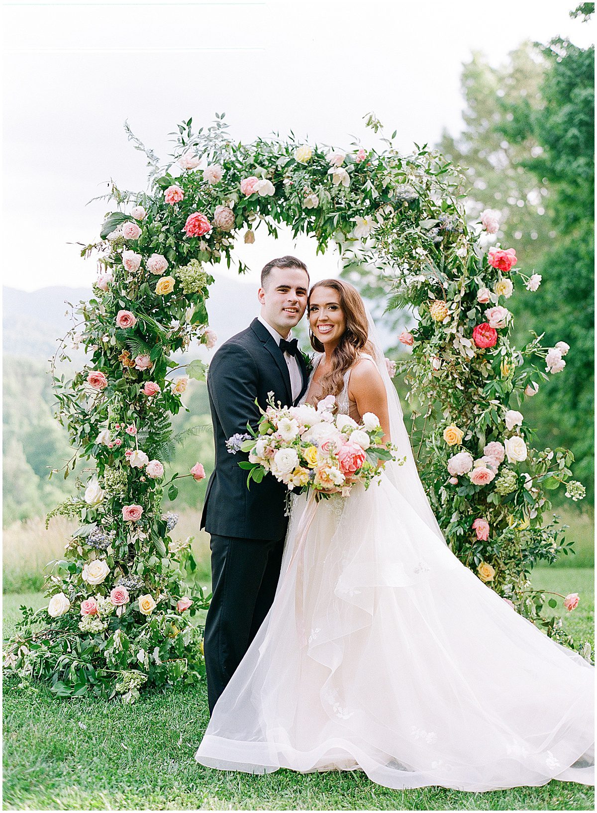 Bride and Groom in Front of Flower Arch at The Ridge Asheville Photo