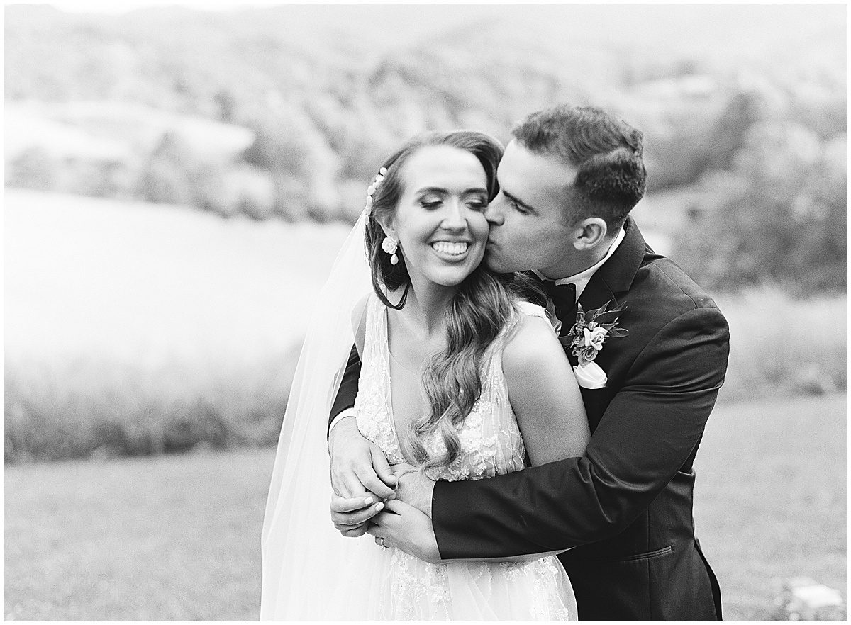 Black and White of Groom Kissing Bride at The Ridge Asheville Photo