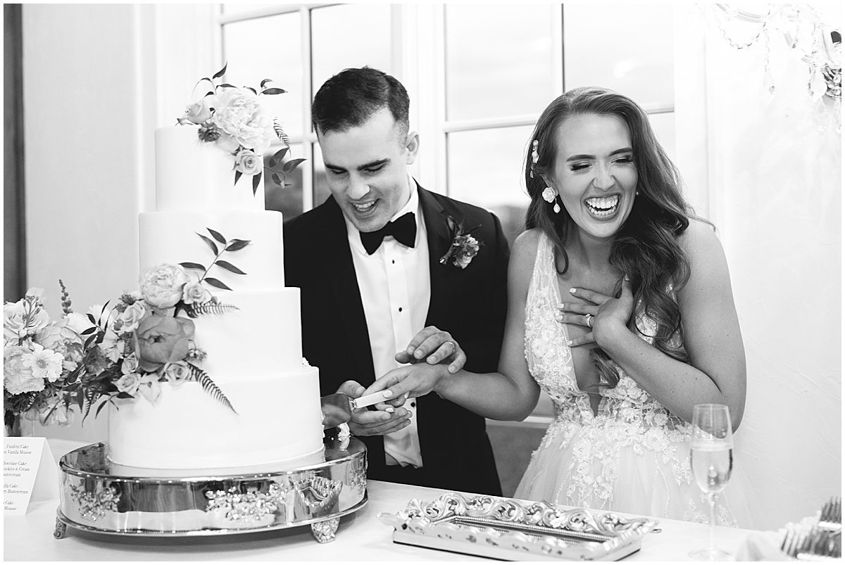 Black and White of Bride and Groom Cutting Cake Photo