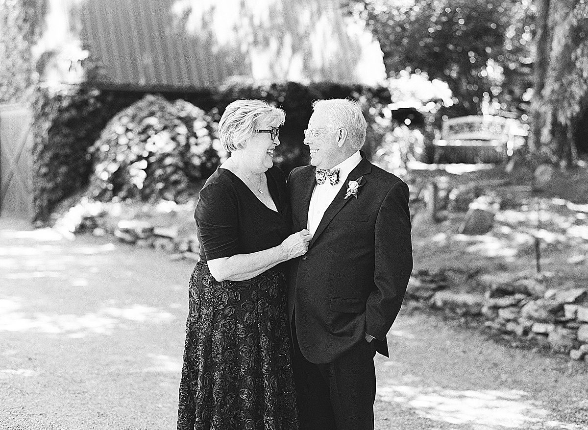 Black and White of Brides Parents Smiling at Each Other Photo