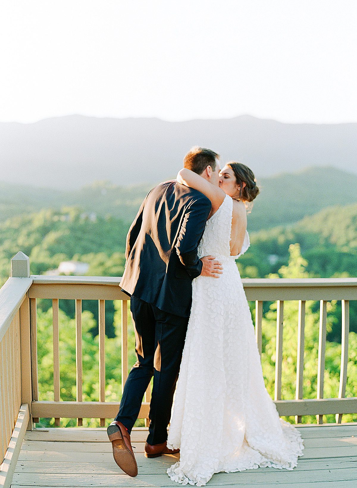 Bride and Groom Kissing at Mountain Top Overlook Photo