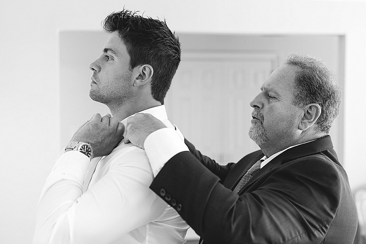 Black and White of Groom Getting Ready with His Dad Photo