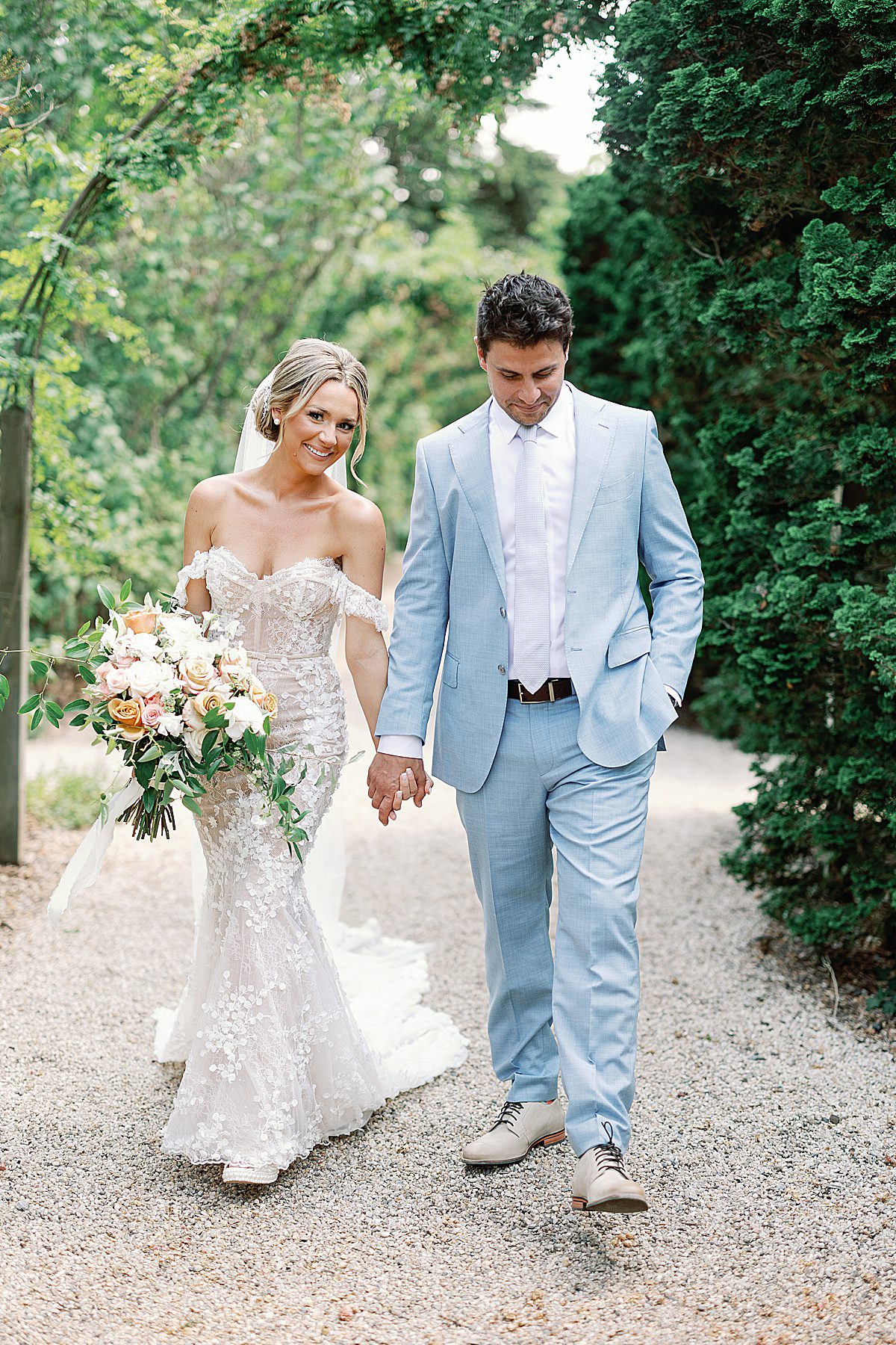 Bride and Groom Walking Holding Hands at Planting Fields Arboretum Photo