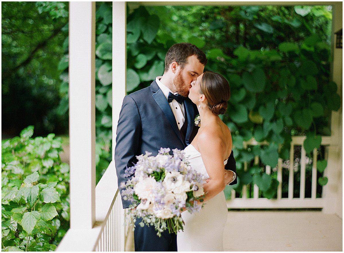 Luxury Wedding Photographer in Highlands NC Bride and Groom Kissing on Porch Photo